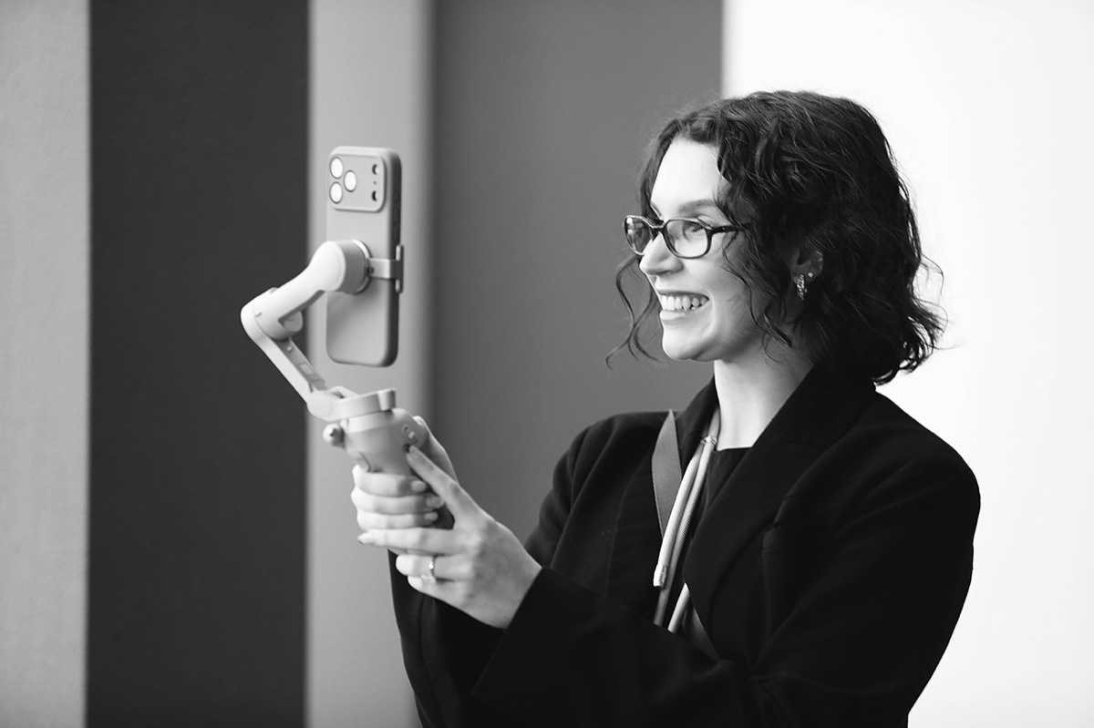 Jaeli Hunter, founder of Once Content, smiling while holding a phone gimbal